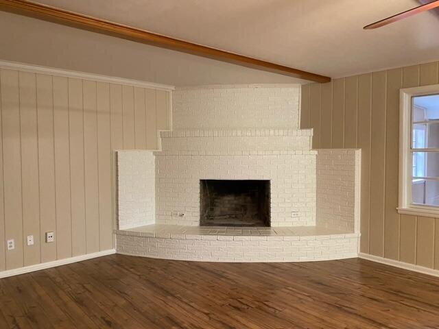 3011 55th Street Lubbock, TX 79413 - Photo 9 of 25 a view of a livingroom with wooden floor and a fireplace