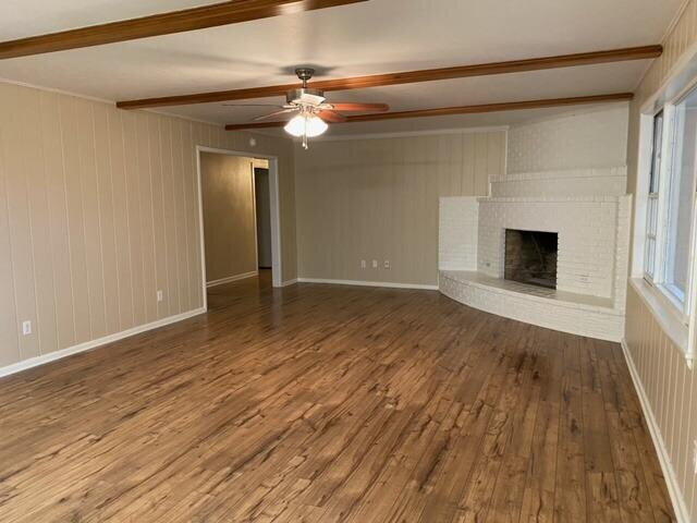 3011 55th Street Lubbock, TX 79413 - Photo 10 of 25 a view of an empty room with wooden floor fireplace and a window
