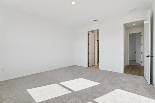 an empty room with closet and a bathroom