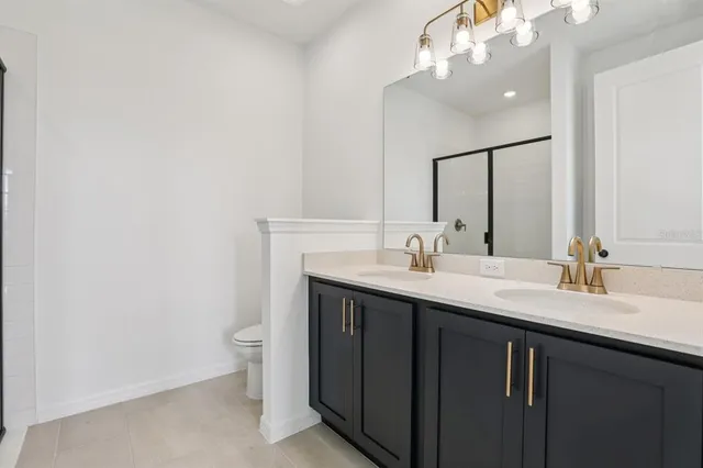 a bathroom with a sink a toilet and a mirror