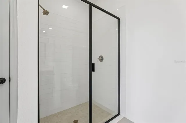 a bathroom with a shower and a mirror