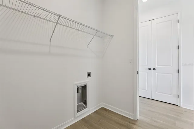 a view of a room with wooden floor