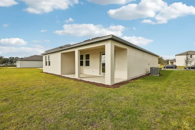 a big white house with a big yard and large trees