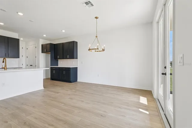a view of kitchen with granite countertop cabinets and refrigerator