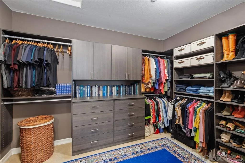 17141 Ralphs Ranch Road San Diego, CA 92127 - Photo 12 of 25 a view of walk in closet with clothes and shoes