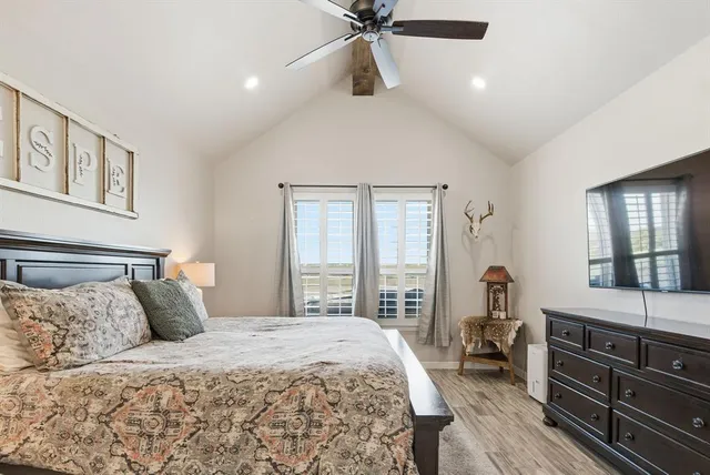 a bedroom with a large bed and a window