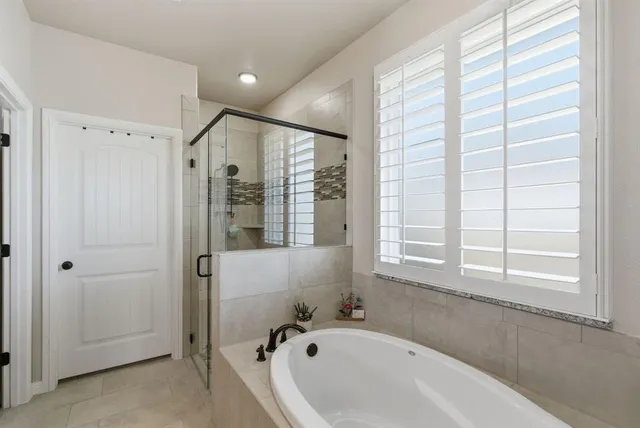 a bathroom with a bathtub and a shower