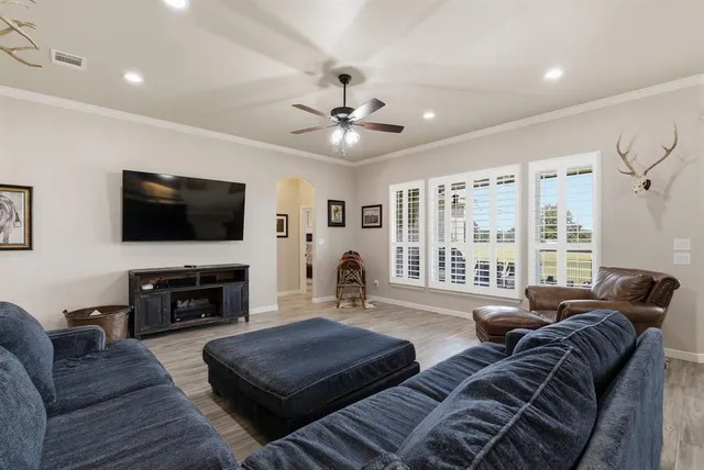 a living room with furniture fireplace and flat screen tv