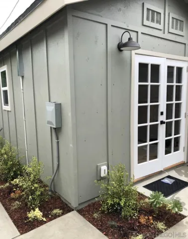 a view of front door and potted plants