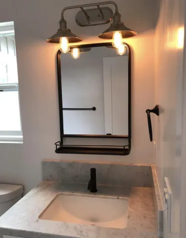 a bathroom with a sink and mirror
