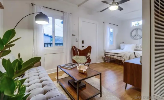 a living room with furniture and a chandelier