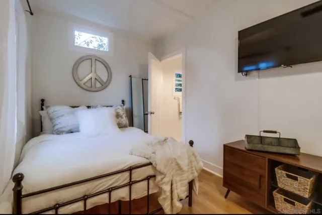 a bedroom with a bed and a flat screen tv