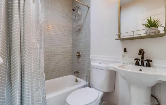 a bathroom with a sink a toilet and bathtub