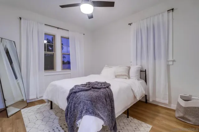 a bedroom with a bed and a window