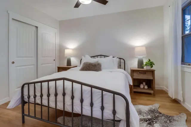 a bedroom with a bed and a table