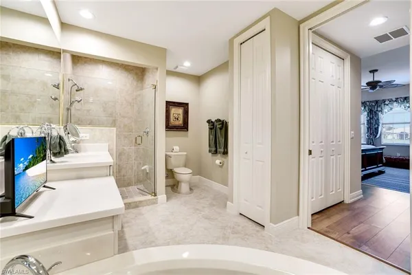 a spacious bathroom with a bathtub shower and toilet