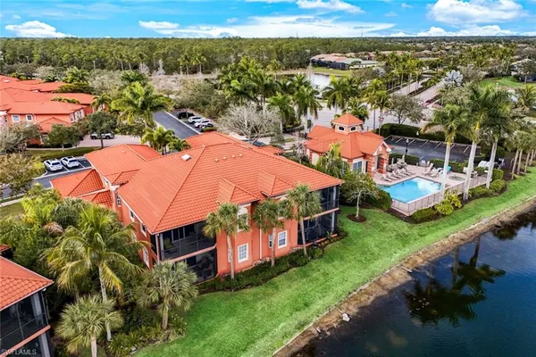 an aerial view of residential houses with outdoor space and swimming pool