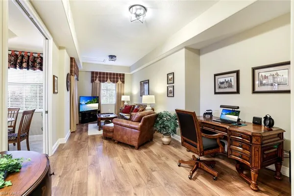 a livingroom with workspace and a couch