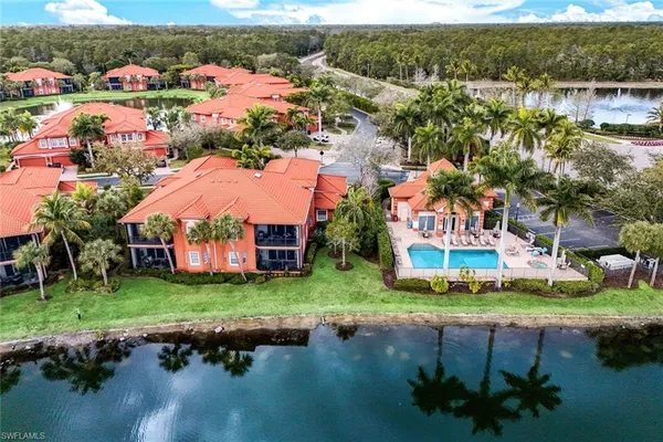 an aerial view of a house with a garden and lake view