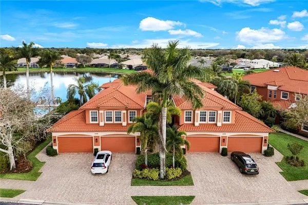 an aerial view of a house with swimming pool garden and lake view
