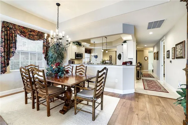 a view of a dining room with furniture and chandelier