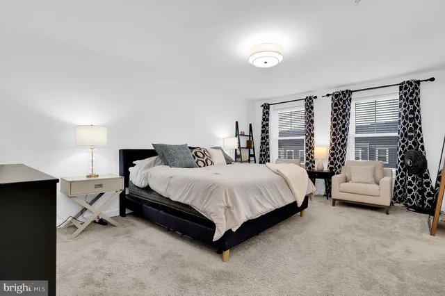 a bedroom with a bed and a large mirror