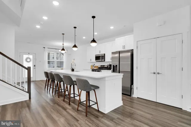 a view of a kitchen with dining table and chairs