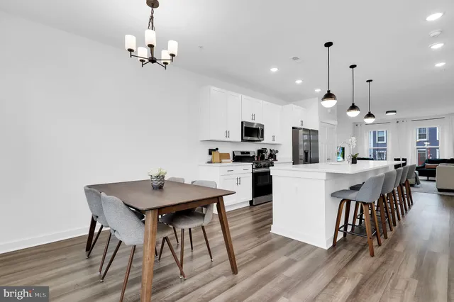 a view of kitchen and living room with wooden floor