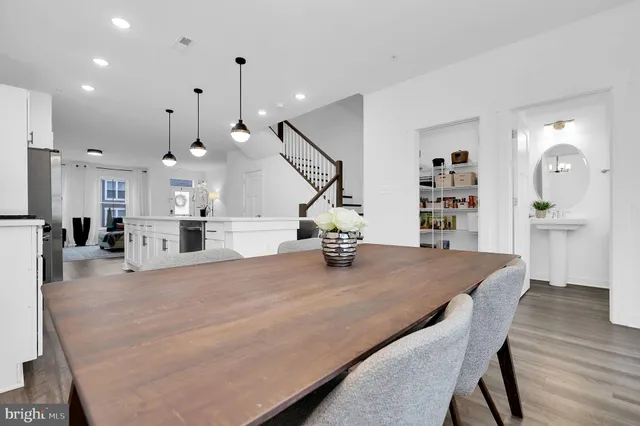a view of a dining room with furniture wooden floor and chandelier
