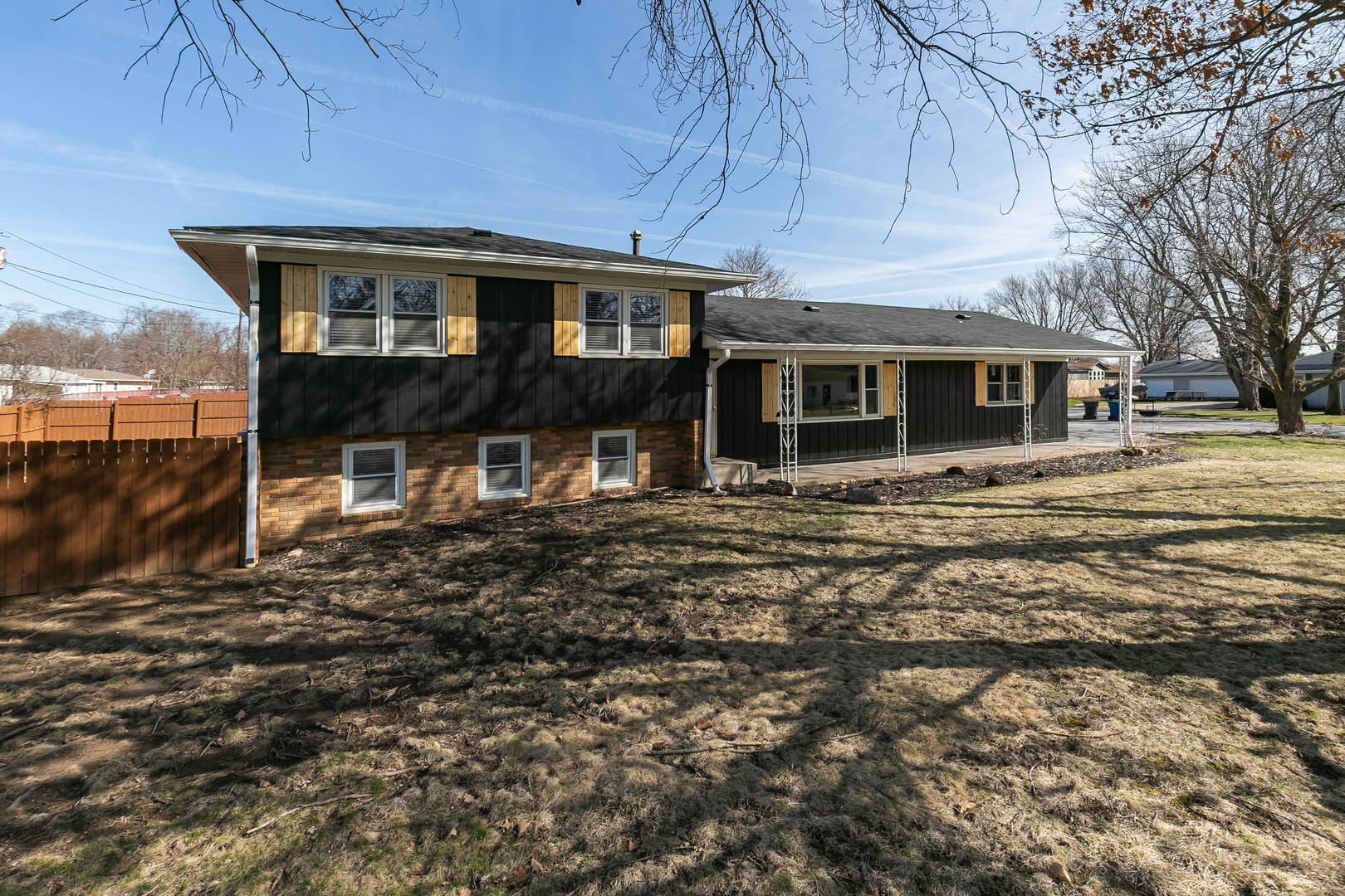 a view of a house with a backyard