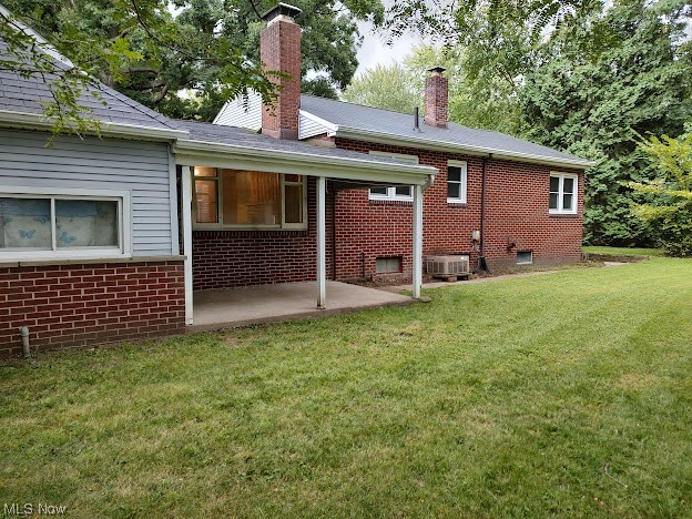 6542 Fairgrounds Road Painesville, OH 44077 - Photo 6 of 26 Back of property featuring a patio area and a lawn