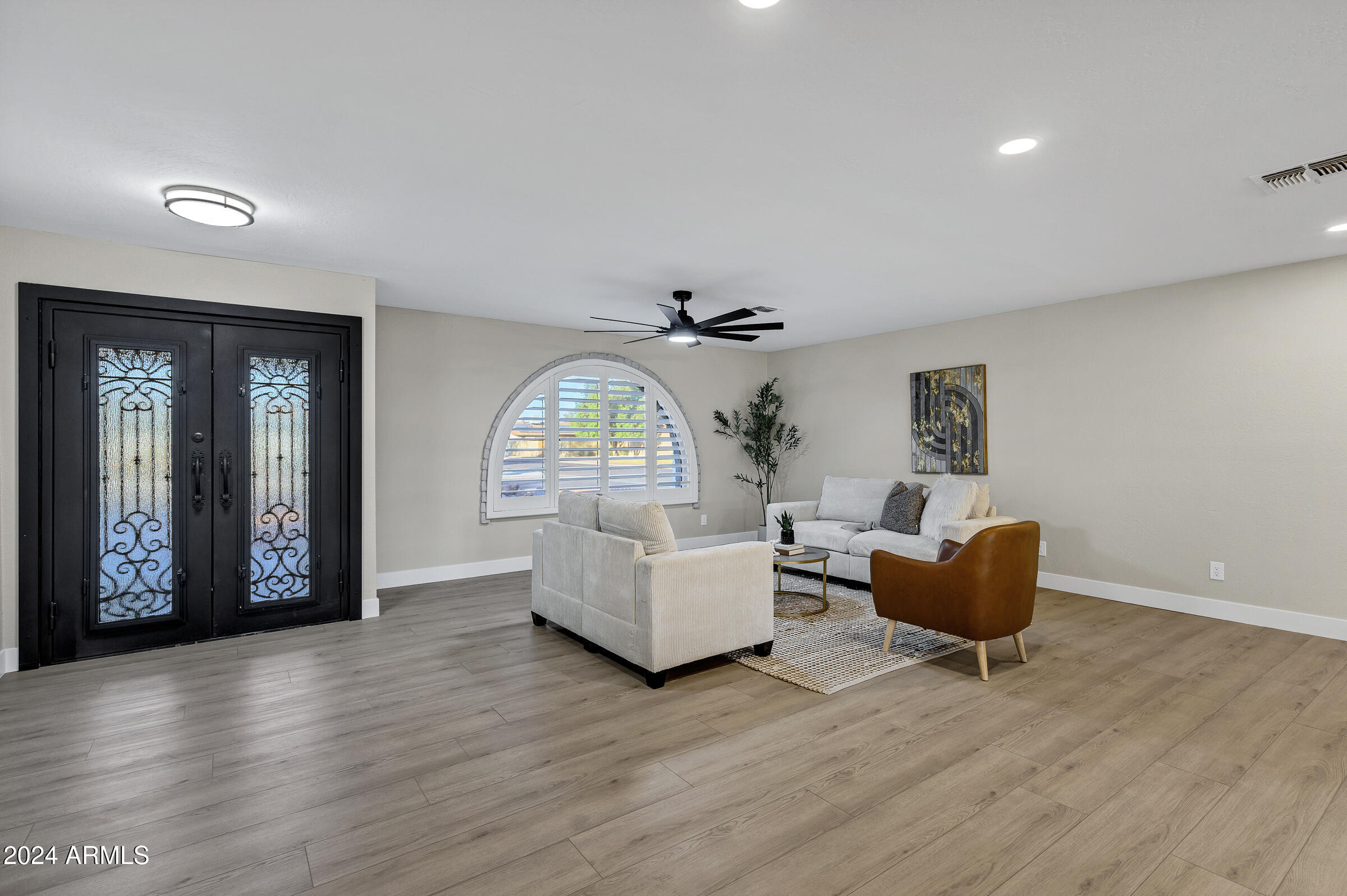 3701 West Phelps Road Phoenix, AZ 85053 - Photo 15 of 46 a living room with furniture and a large window