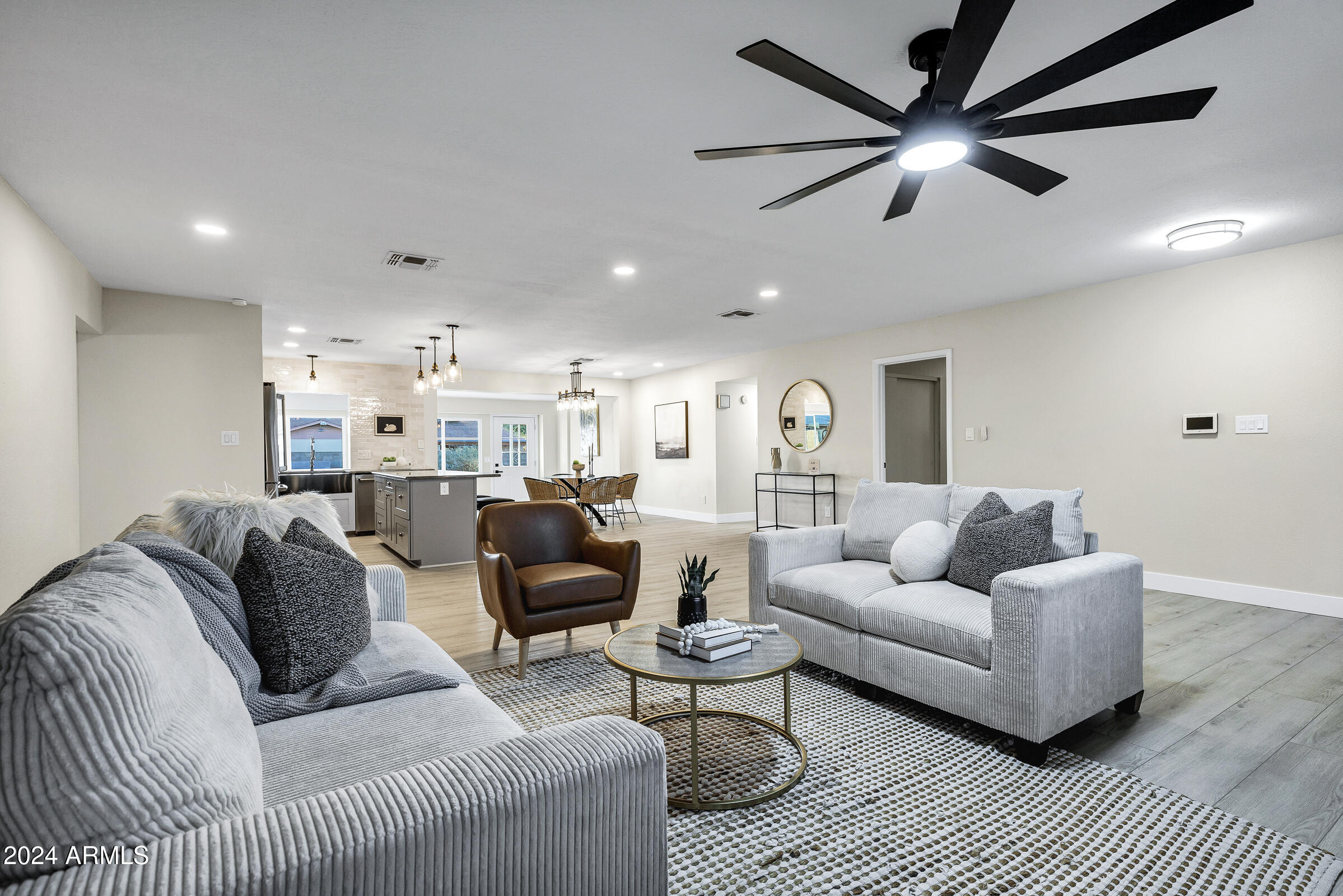 3701 West Phelps Road Phoenix, AZ 85053 - Photo 17 of 46 a living room with furniture and a ceiling fan
