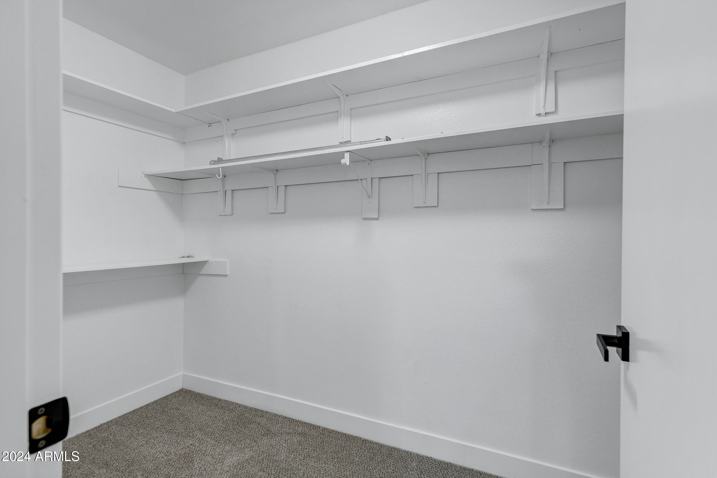 3701 West Phelps Road Phoenix, AZ 85053 - Photo 34 of 46 a view of walk in closet with empty racks