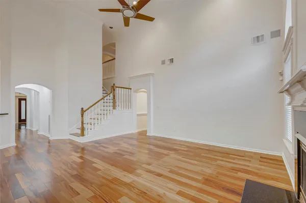 a view of a livingroom with wooden floor and white walls