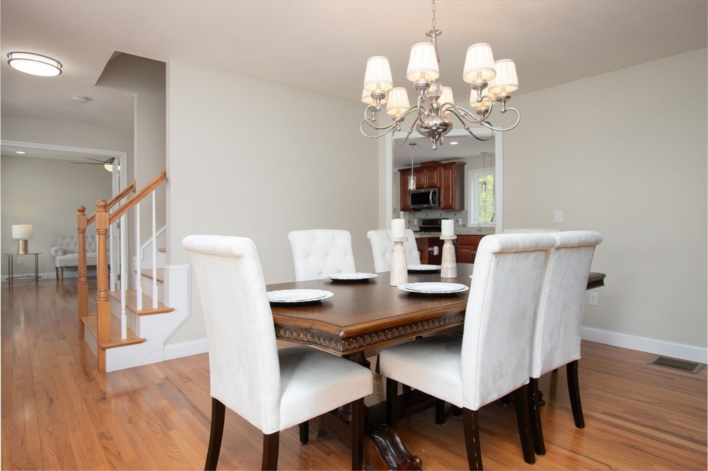 78 Tavern Road Groton, MA 01450 - Photo 11 of 41 a view of a dining room with furniture and wooden floor