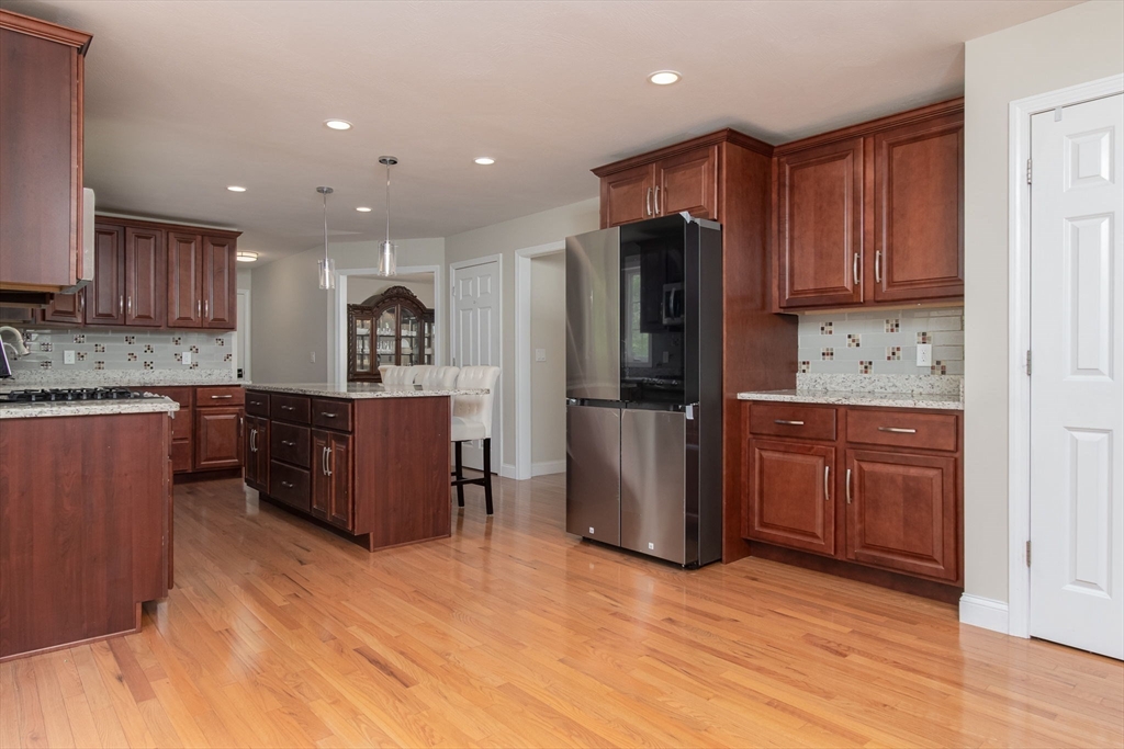78 Tavern Road Groton, MA 01450 - Photo 13 of 41 a kitchen with stainless steel appliances granite countertop a refrigerator and a stove top oven