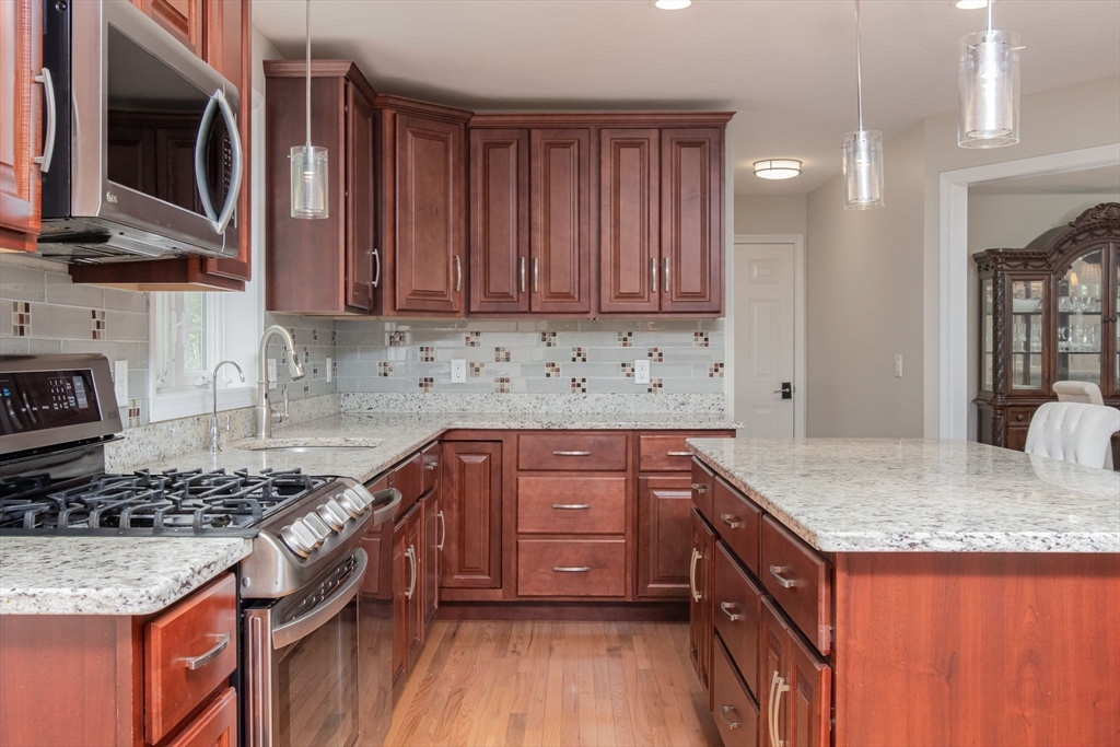 78 Tavern Road Groton, MA 01450 - Photo 14 of 41 a kitchen with stainless steel appliances granite countertop a stove a sink and a microwave