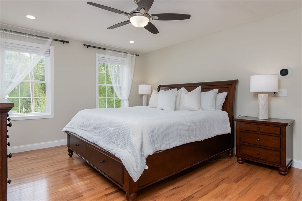 78 Tavern Road Groton, MA 01450 - Photo 17 of 41 a large bed sitting in a bedroom next to a window and a chandelier