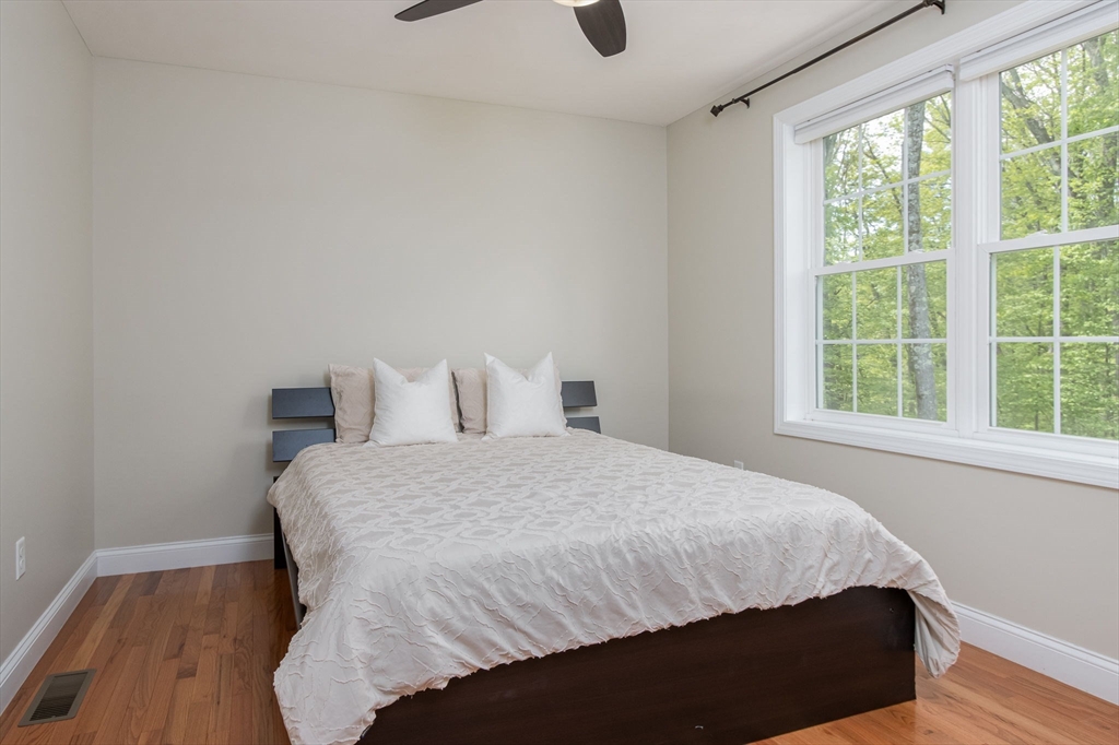 78 Tavern Road Groton, MA 01450 - Photo 22 of 41 a bedroom with a bed and wooden floor