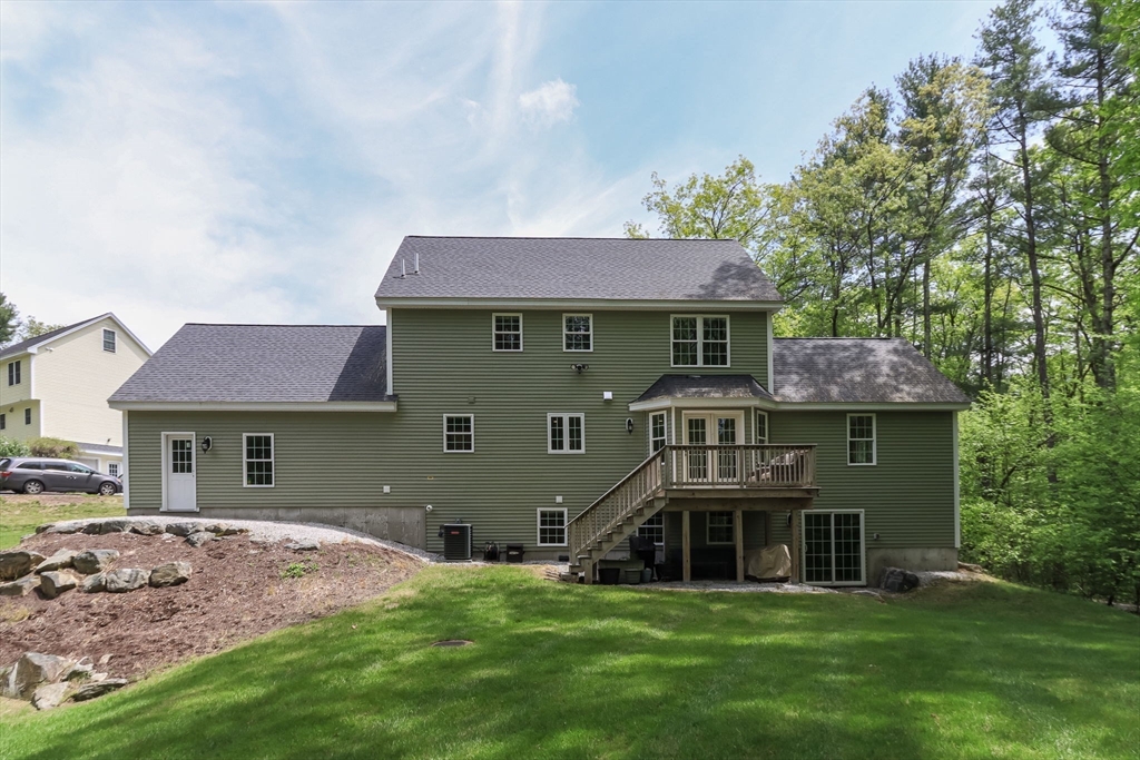 78 Tavern Road Groton, MA 01450 - Photo 34 of 41 a front view of a house with a garden