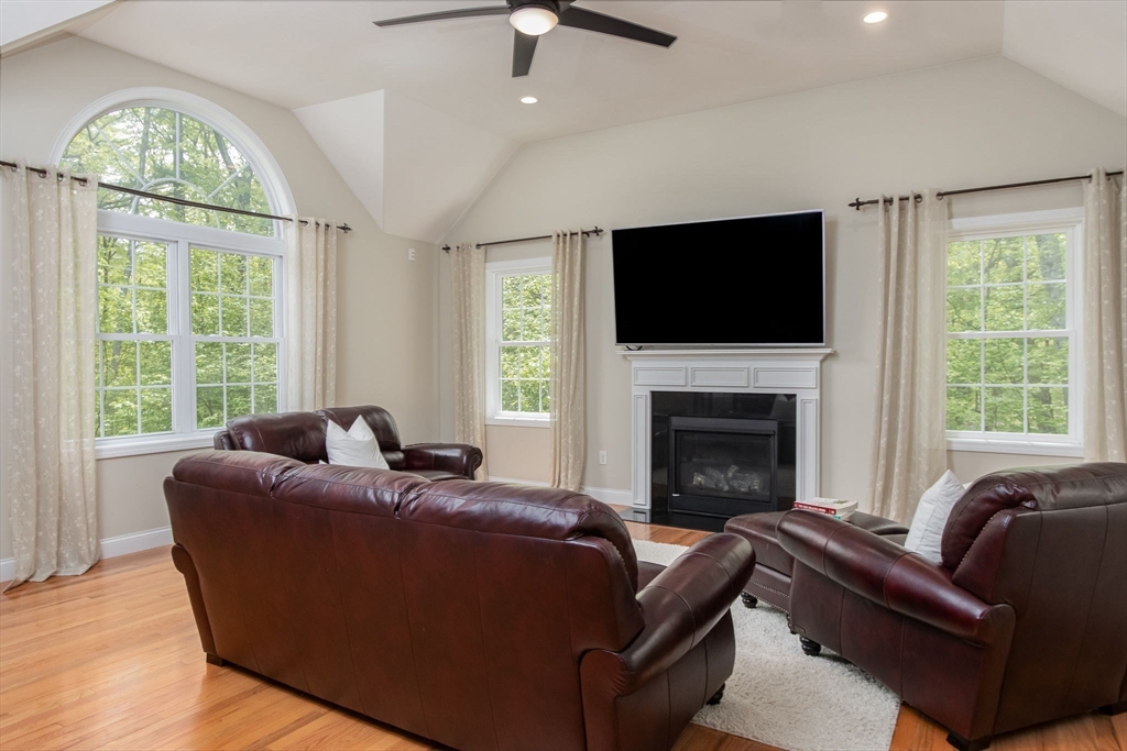 78 Tavern Road Groton, MA 01450 - Photo 5 of 41 a living room with furniture a flat screen tv and a fireplace