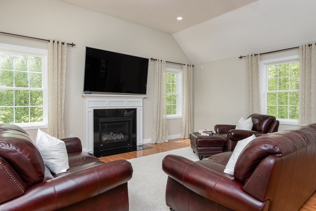 78 Tavern Road Groton, MA 01450 - Photo 7 of 41 a living room with furniture a flat screen tv and a fireplace