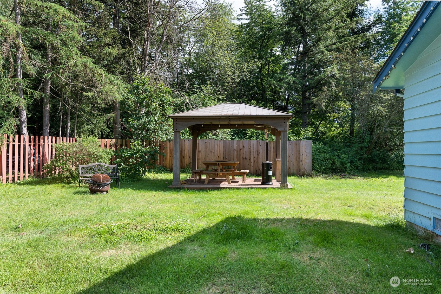 1275 West Axton Road Ferndale, WA 98248 - Photo 28 of 30 a view of a patio with a table and chairs under an umbrella