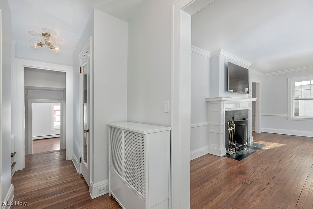 2596 Ashton Road Cleveland, OH 44118 - Photo 16 of 43 Corridor featuring dark hardwood / wood-style flooring, baseboard heating, and ornamental molding