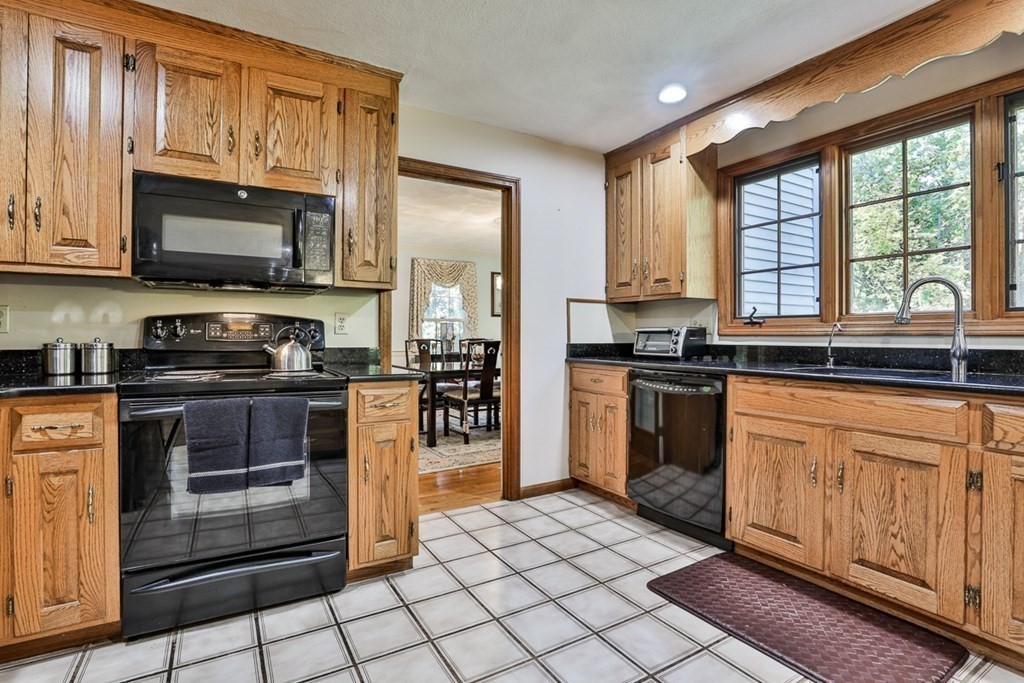 18 Forest Lane Boxford, MA 01921 - Photo 17 of 33 a kitchen with stainless steel appliances granite countertop a stove a sink and a microwave