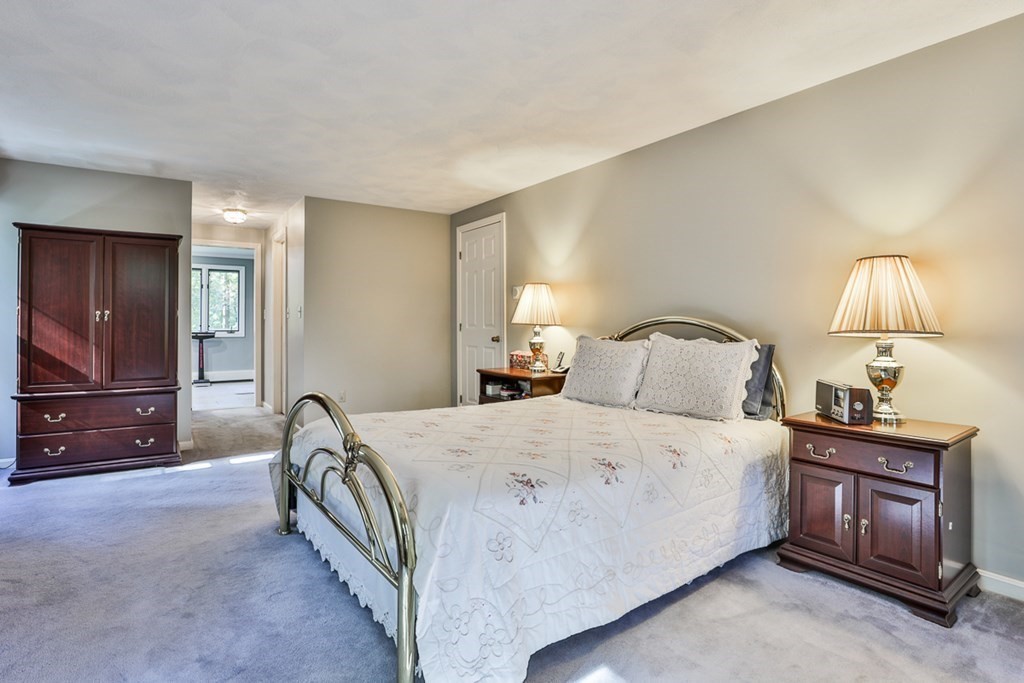18 Forest Lane Boxford, MA 01921 - Photo 26 of 33 a bedroom with a bed and a lamp on table