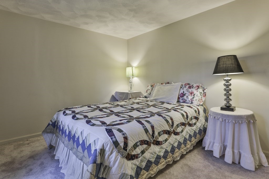 18 Forest Lane Boxford, MA 01921 - Photo 31 of 33 a bedroom with a bed and a lamp
