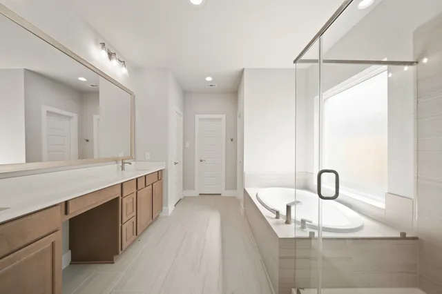 a large bathroom with a double vanity sink and a mirror