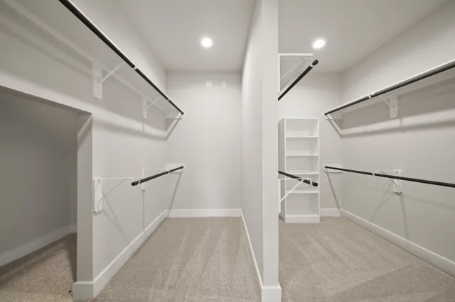 a view of a hallway with white walls and stairs